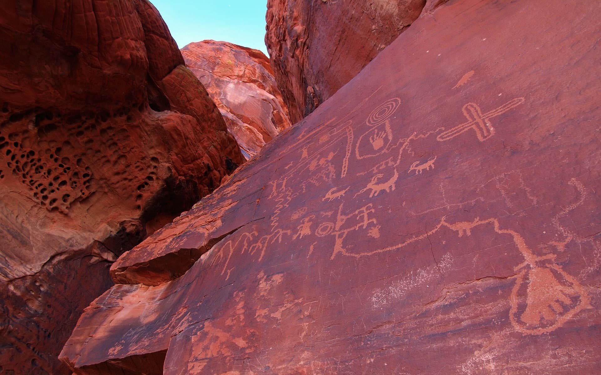 Native American petroglyphs carved into red sandstone