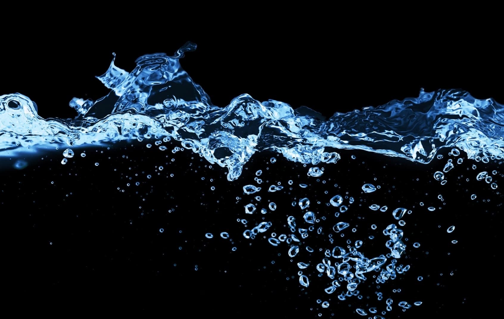 Water splashing upward against a black background